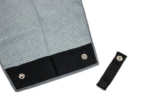Golf towel magnet accessory with silver snap closure. Shown beside grey microfiber greenside golf towel.