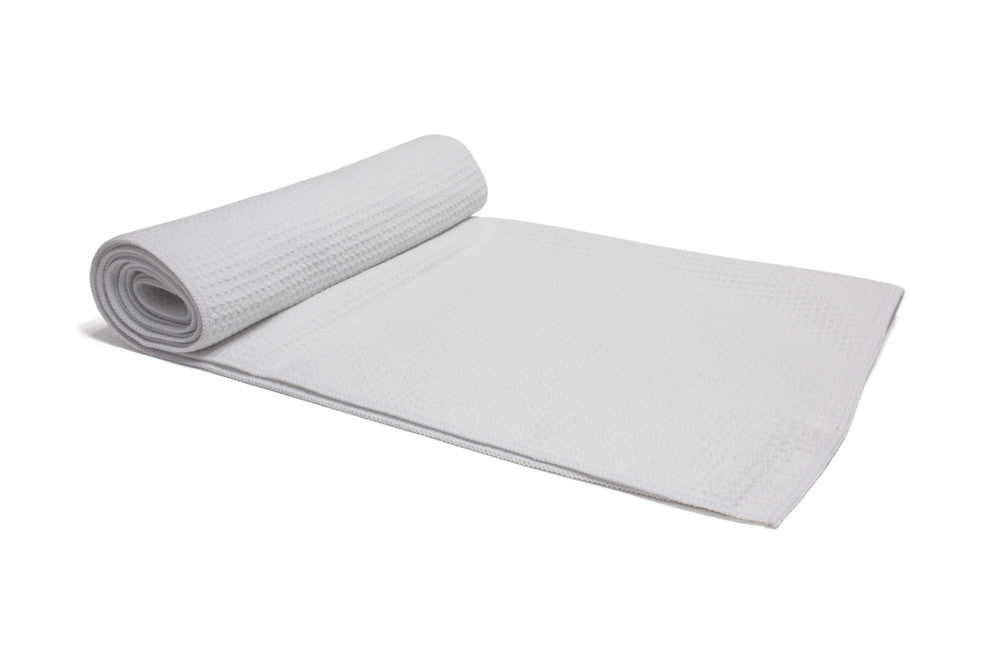 Large, rolled microfiber sports towel featuring a cooling and absorbent waffle weave.